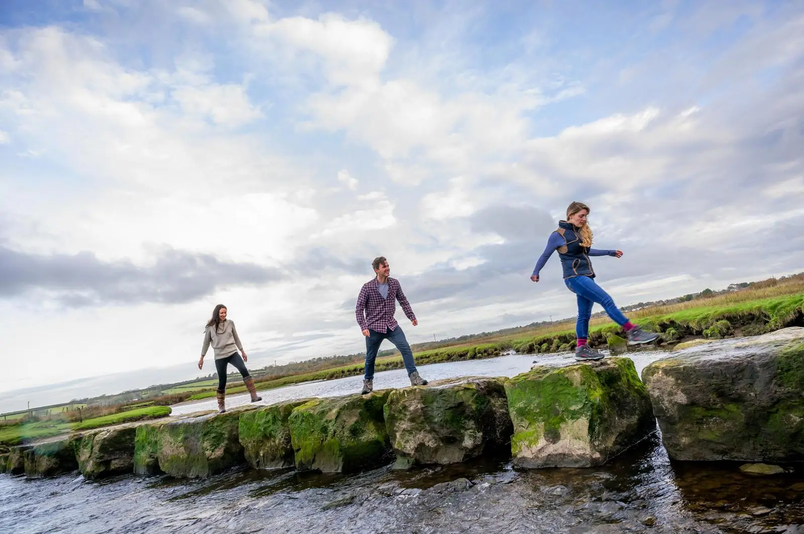 People walking on the stepping stones at low tide