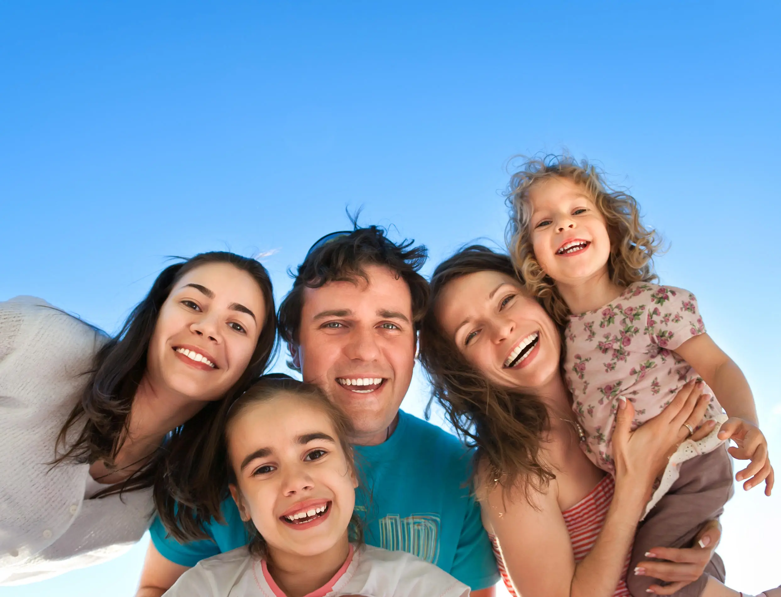 Family smiling into the camera